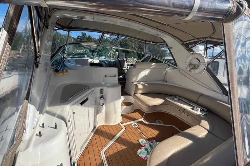 Slide: The Image of 2002 Cruisers Yachts interior with seating, wooden flooring, and clear canopy. - 5