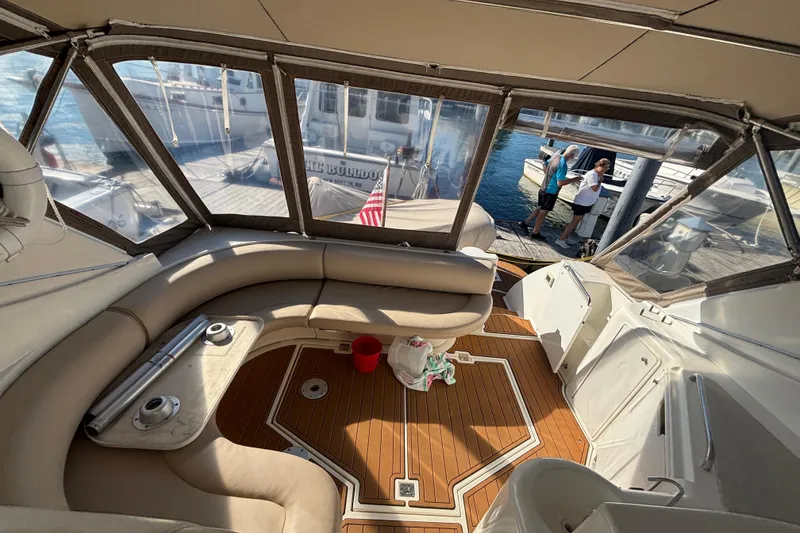 Slide: The Image of Interior of a 2002 Cruisers Yachts boat with seating and dock view. - 6