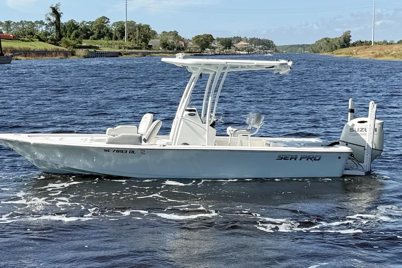 Slide: The Image of 2020 Sea Pro 228 Center Console boat cruising on a scenic waterway. - 1