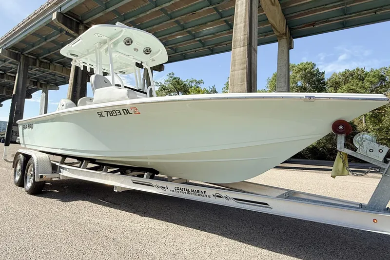 Slide: The Image of 2020 Sea Pro 228 Center Console boat on trailer under bridge. - 10