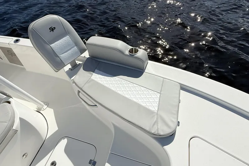 Slide: The Image of 2020 Sea Pro 228 Center Console boat interior with cushioned seating and cup holder. - 13