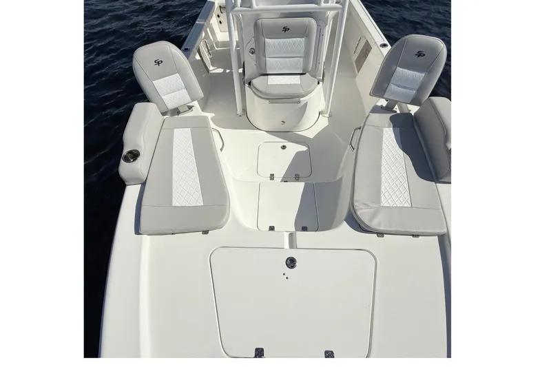 Slide: The Image of 2020 Sea Pro 228 Center Console boat interior with cushioned seating and storage compartments. - 14