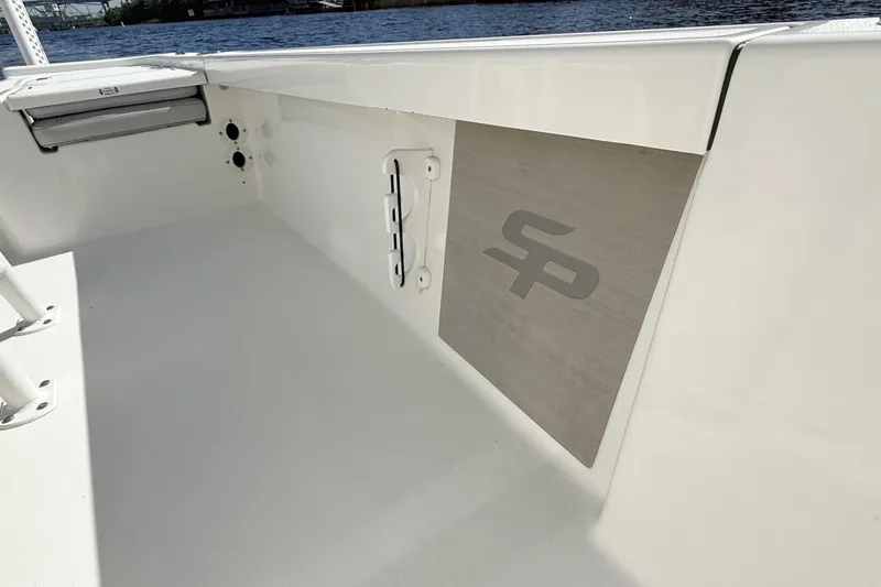 Slide: The Image of 2020 Sea Pro 228 Center Console boat interior with logo, docked by the water. - 15