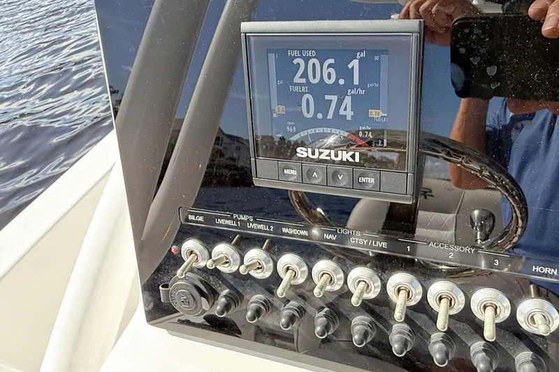 Slide: The Image of 2020 Sea Pro 228 Center Console dashboard with Suzuki fuel gauge and control switches. - 17