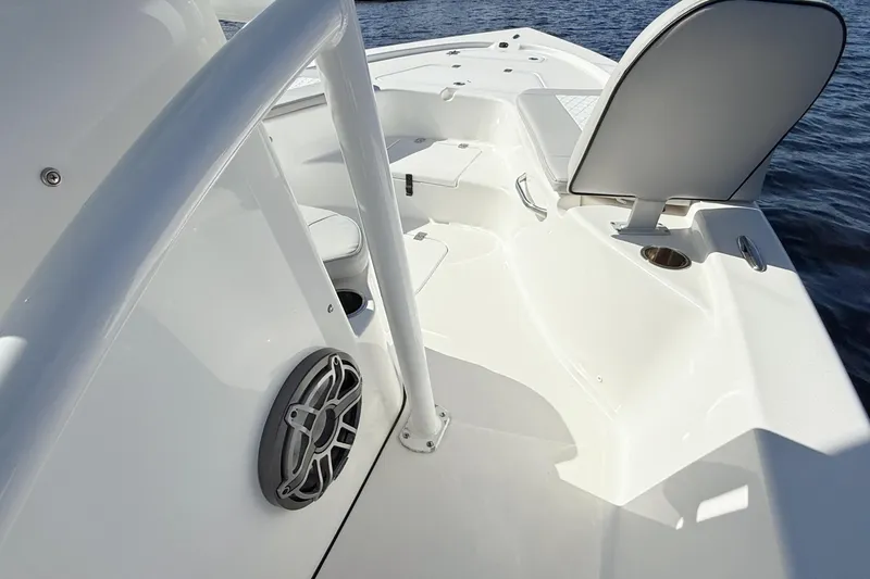 Slide: The Image of 2020 Sea Pro 228 Center Console boat interior with seating and speaker, on water. - 18