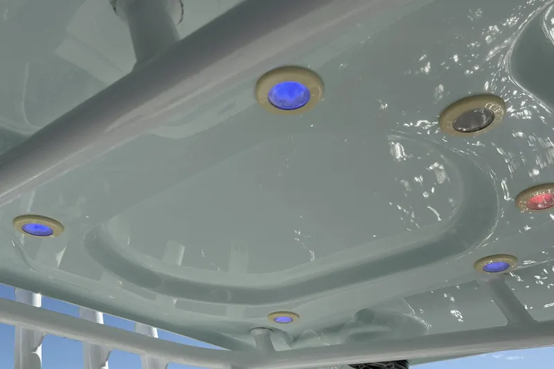 Slide: The Image of 2020 Sea Pro 228 Center Console boat with colorful LED lights on the underside. - 22