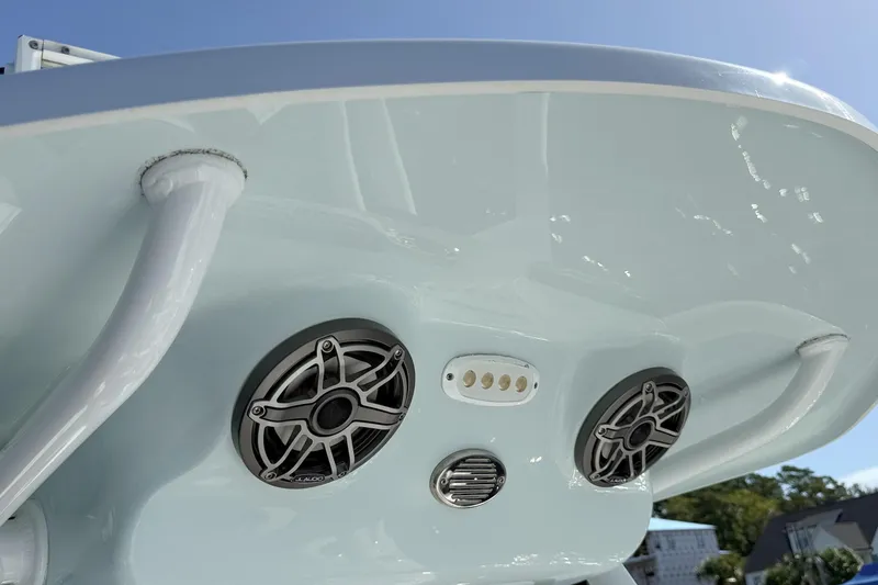 Slide: The Image of 2020 Sea Pro 228 Center Console boat speakers and lights under blue sky. - 23