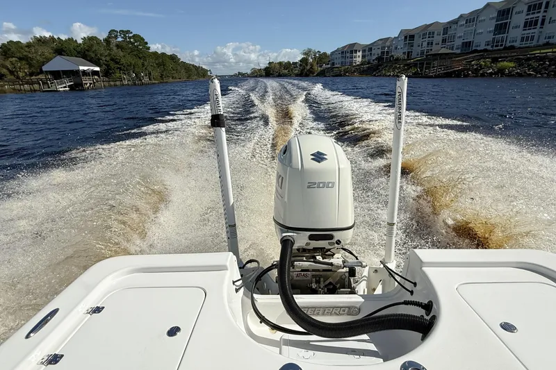 Slide: The Image of 2020 Sea Pro 228 Center Console boat cruising on a scenic waterway. - 4