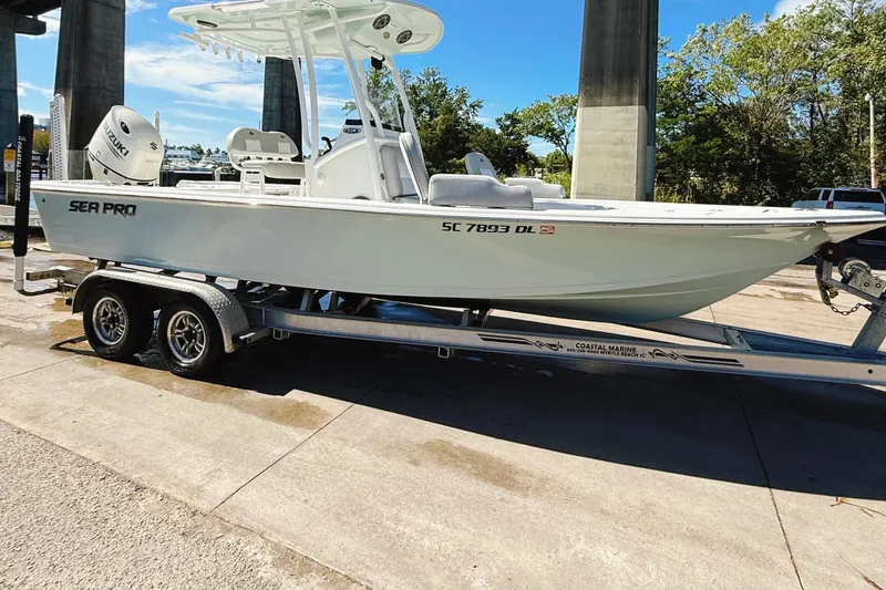 Slide: The Image of 2020 Sea Pro 228 Center Console boat on trailer, parked outdoors under a bridge. - 5