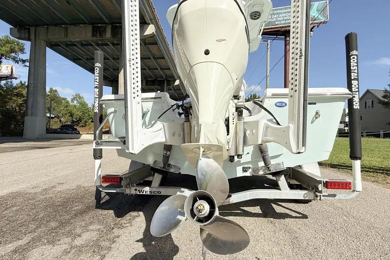 Slide: The Image of 2020 Sea Pro 228 Center Console boat on trailer, under bridge, rear view. - 9