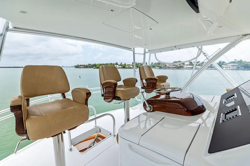 Slide: The Image of Luxurious helm station on 2018 Viking 80 Convertible yacht with leather seats and controls. - 11