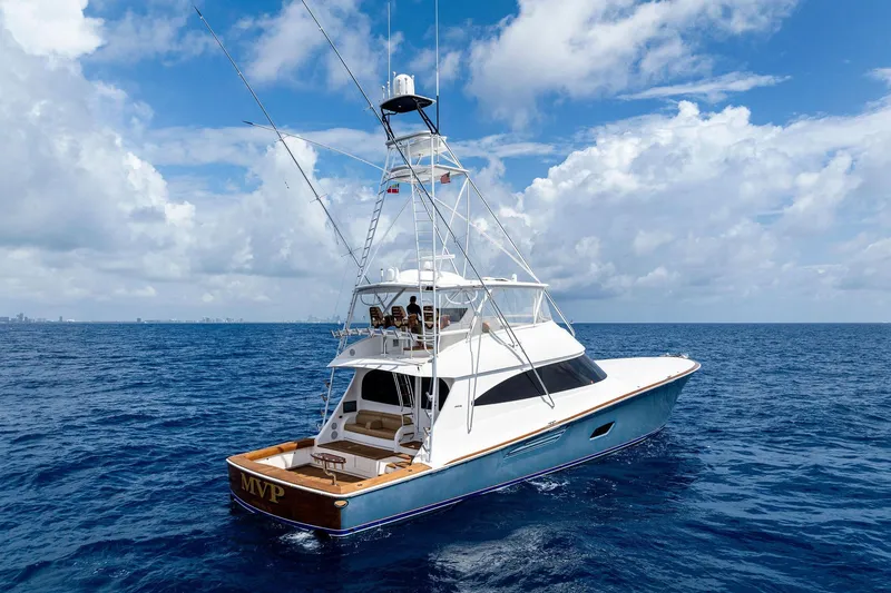 Slide: The Image of 2018 Viking 80 Convertible yacht cruising on open ocean under blue sky. - 6