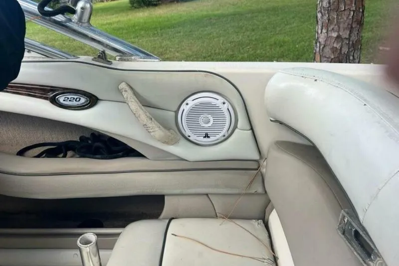 Slide: The Image of Interior of a 2003 Sea Ray 220 Bow Rider boat, featuring speaker and seating. - 10