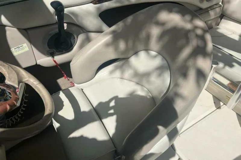 Slide: The Image of Interior of 2003 Sea Ray 220 Bow Rider boat with steering wheel and seating. - 12