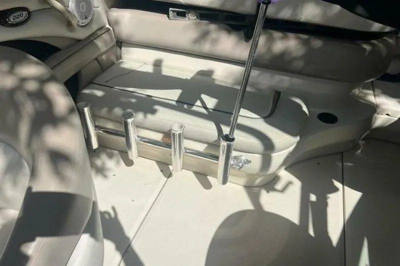 Slide: The Image of Interior of 2003 Sea Ray 220 Bow Rider boat with seating and rod holders. - 13
