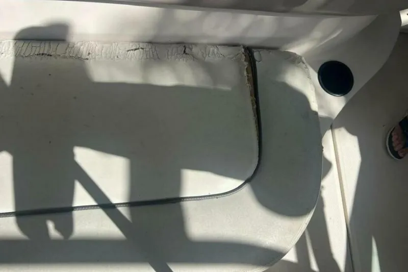 Slide: The Image of Interior of 2003 Sea Ray 220 Bow Rider showing seat damage and shadows. - 14