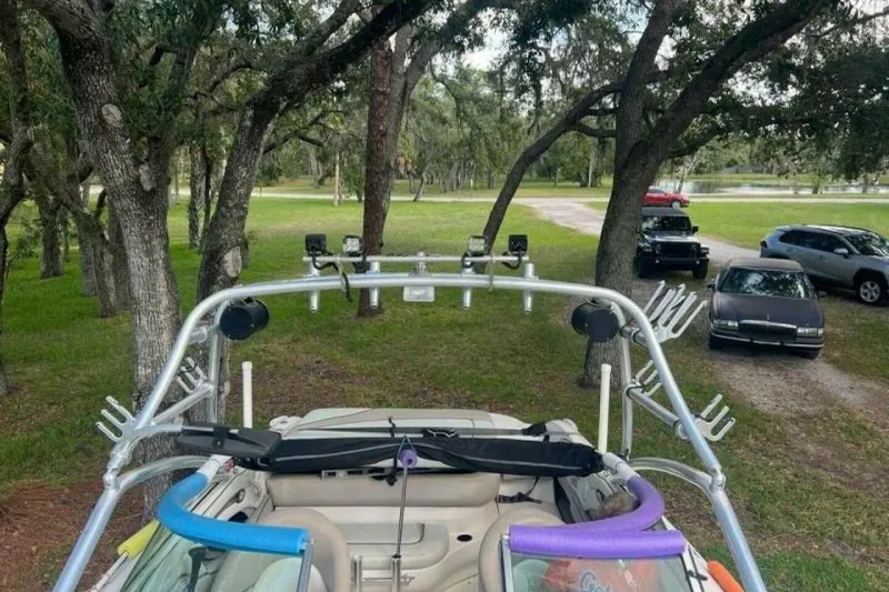 Slide: The Image of 2003 Sea Ray 220 Bow Rider with wakeboard tower in a wooded area. - 17