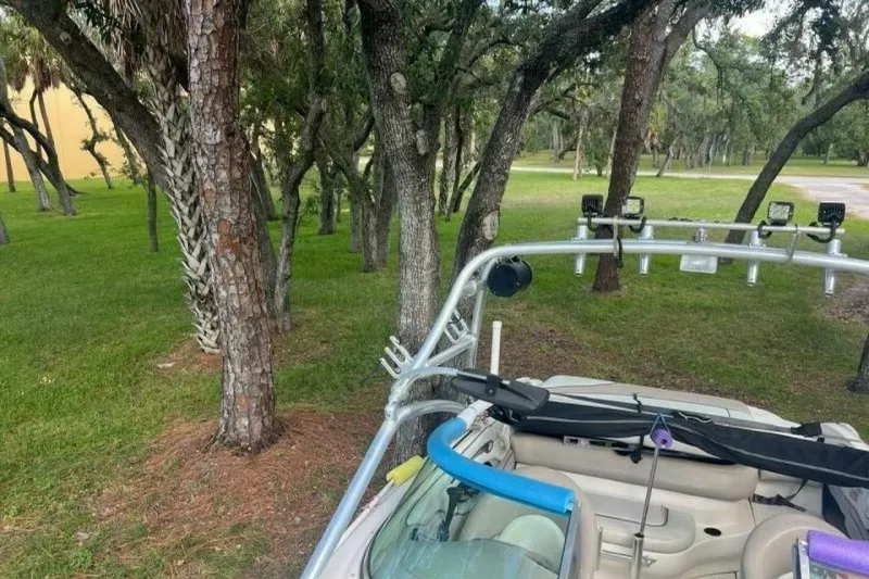 Slide: The Image of 2003 Sea Ray 220 Bow Rider parked near trees in a grassy area. - 18