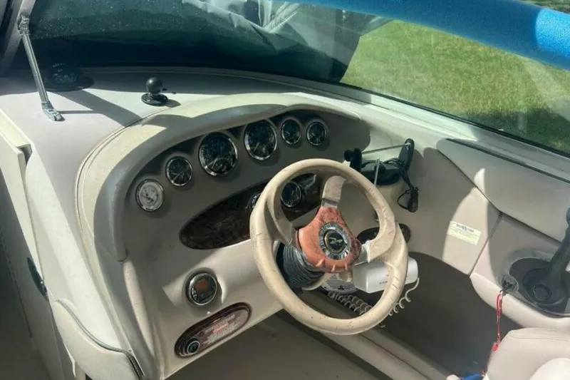 Slide: The Image of 2003 Sea Ray 220 Bow Rider dashboard with steering wheel and gauges. - 6