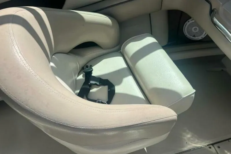 Slide: The Image of 2003 Sea Ray 220 Bow Rider interior with beige seating and safety strap. - 8