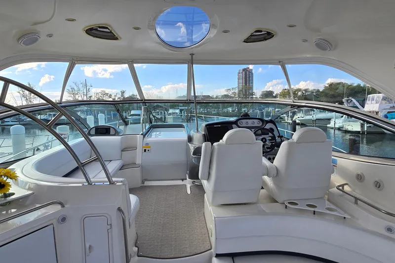 Slide: The Image of 2005 Cruisers Yachts 500 Express interior with white seating and panoramic windows. - 17