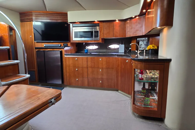 Slide: The Image of 2005 Cruisers Yachts 500 Express cockpit with sleek design and marina view. - 25