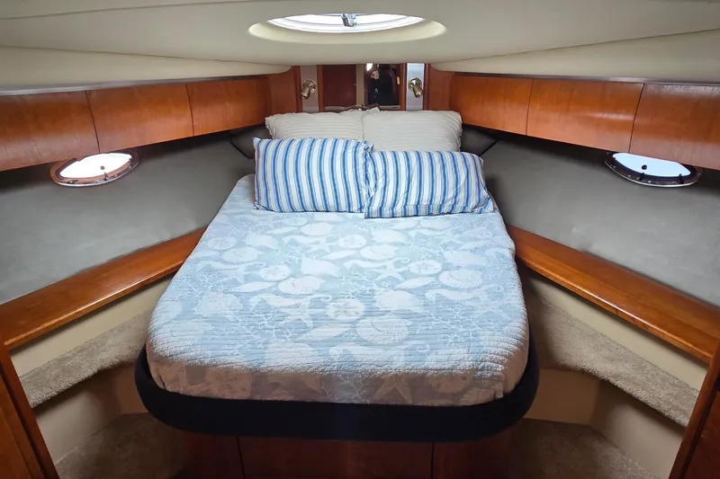 Slide: The Image of Luxurious cabin interior of 2005 Cruisers Yachts 500 Express with cozy bedding. - 30