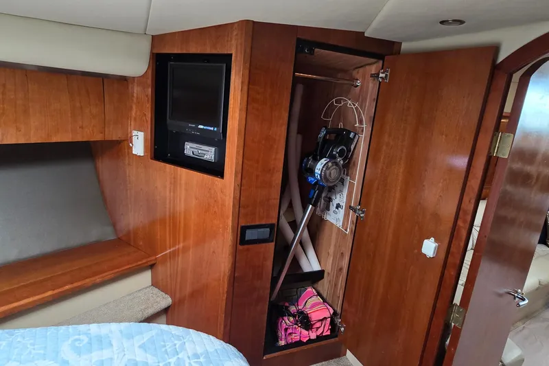 Slide: The Image of Luxurious cabin interior of 2005 Cruisers Yachts 500 Express with elegant wood finish. - 31