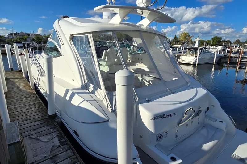 Slide: The Image of 2005 Cruisers Yachts 500 Express docked under a clear blue sky. - 4