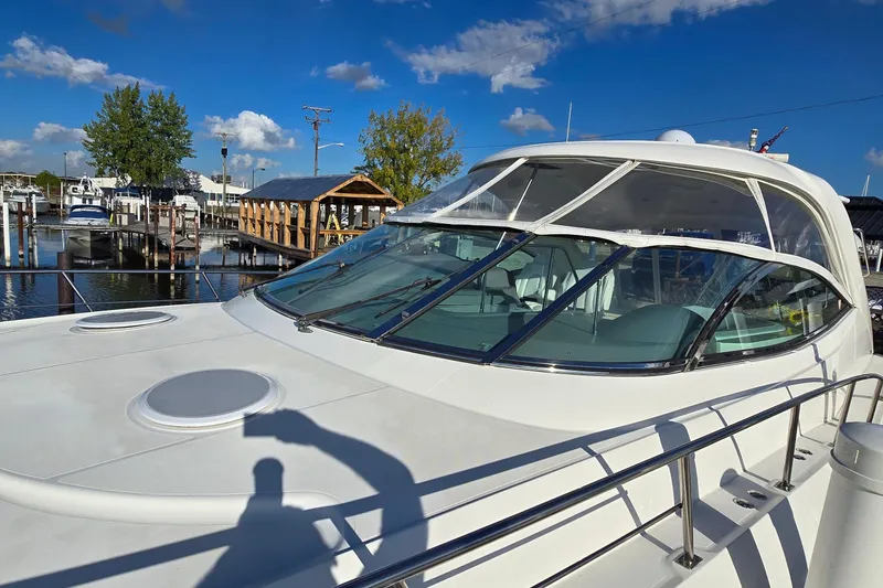 Slide: The Image of 2005 Cruisers Yachts 500 Express bow with open anchor hatch, sparkling water view. - 6