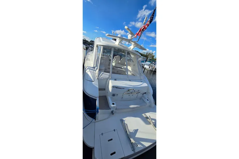 Slide: The Image of 2005 Cruisers Yachts 500 Express docked under a clear blue sky. - 9