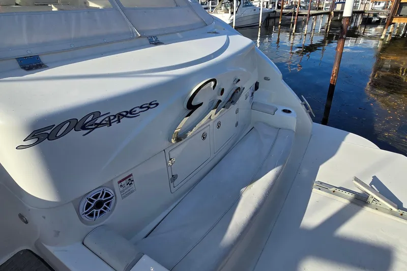 Slide: The Image of Interior view of 2005 Cruisers Yachts 500 Express helm with marina backdrop. - 11