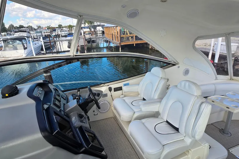 Slide: The Image of 2005 Cruisers Yachts 500 Express interior with seating, TV, and outdoor view. - 19