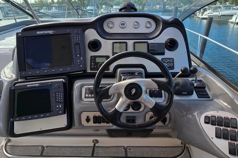 Slide: The Image of 2005 Cruisers Yachts 500 Express interior with TV, flowers, and mini-fridge. - 21