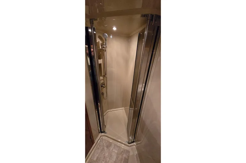 Slide: The Image of 2005 Cruisers Yachts 500 Express interior with TV, microwave, and kitchenette. - 44