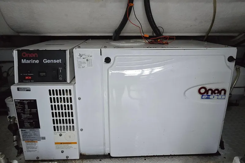 Slide: The Image of Washing machine inside 2005 Cruisers Yachts 500 Express, wooden cabinet doors open. - 51