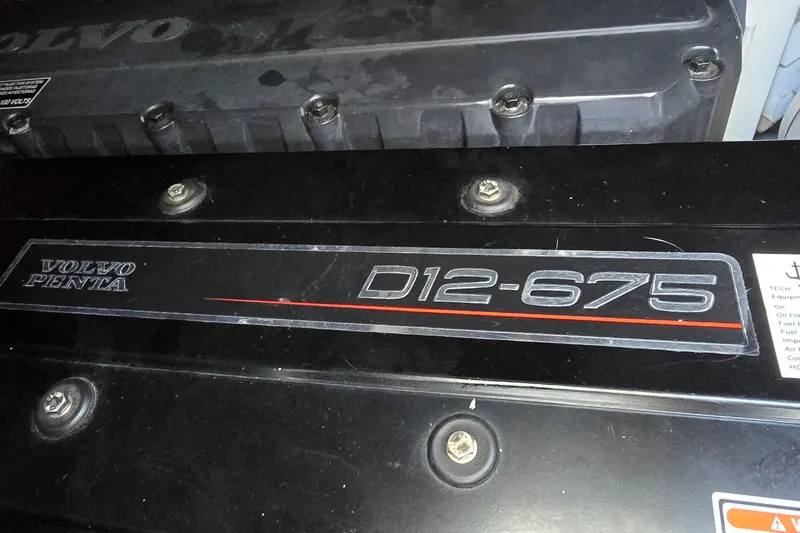 Slide: The Image of Interior of 2005 Cruisers Yachts 500 Express, featuring a wooden bathroom entrance. - 52