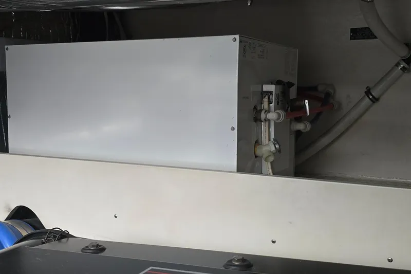 Slide: The Image of Engine room of 2005 Cruisers Yachts 500 Express, featuring mechanical components and wiring. - 57