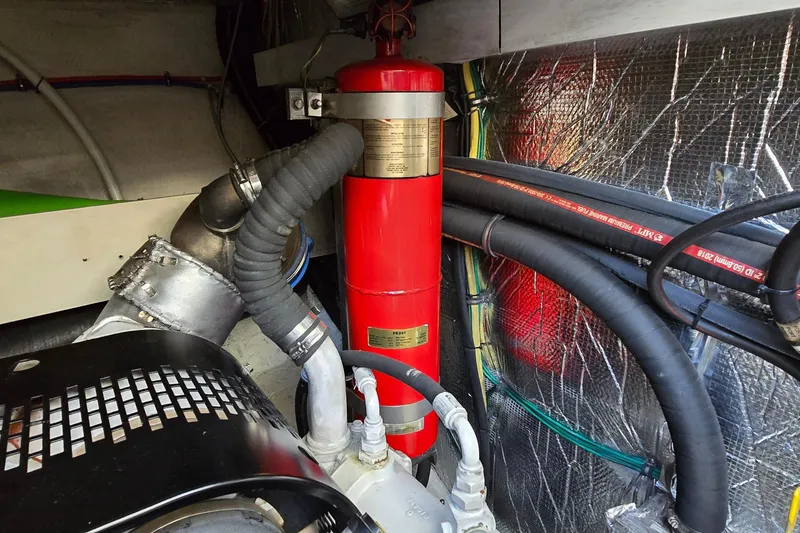 Slide: The Image of Engine room of 2005 Cruisers Yachts 500 Express, showcasing detailed machinery and components. - 59