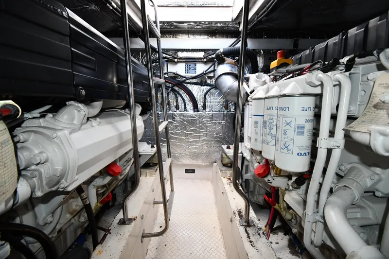 Slide: The Image of Engine room of 2005 Cruisers Yachts 500 Express, showcasing dual engines and mechanical components. - 61