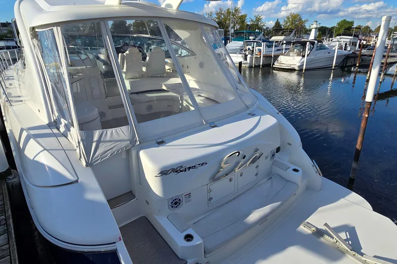 Slide: The Image of 2005 Cruisers Yachts 500 Express docked at marina under blue sky. - 8