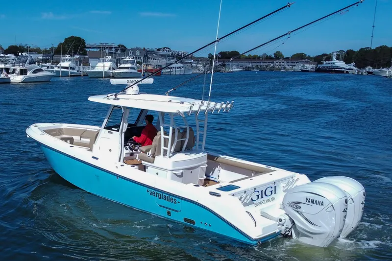 Slide: The Image of 2023 Everglades 335 Center Console boat with Yamaha engines in a marina setting. - 11