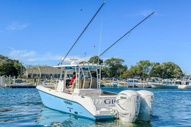 Slide: The Image of 2023 Everglades 335 Center Console boat with dual Yamaha engines on a sunny day. - 18