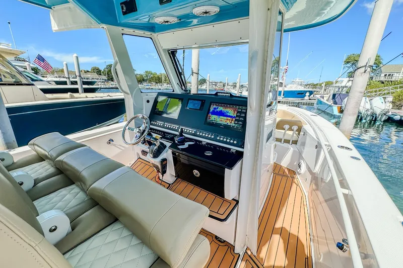 Slide: The Image of 2023 Everglades 335 Center Console boat interior with advanced navigation system and luxurious seating. - 21