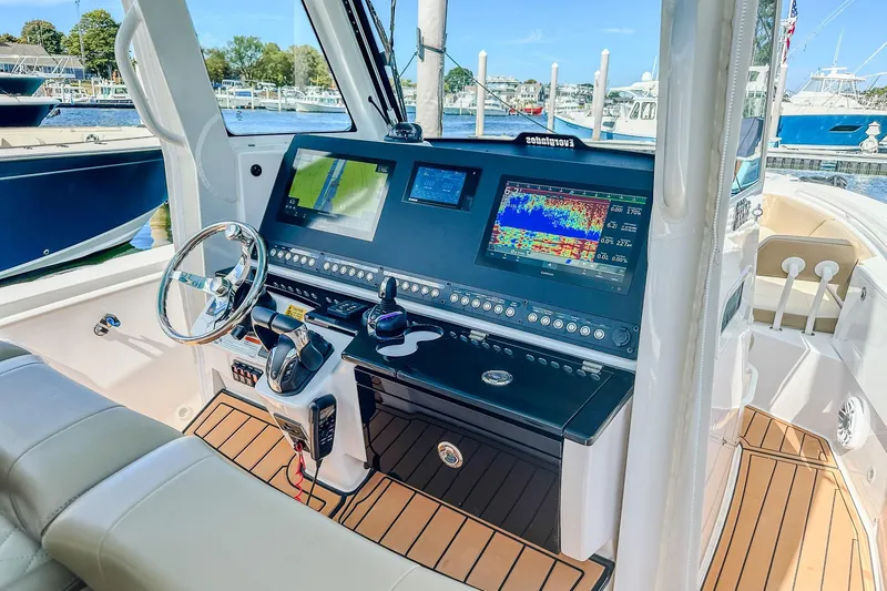 Slide: The Image of 2023 Everglades 335 Center Console boat dashboard with advanced navigation displays. - 22