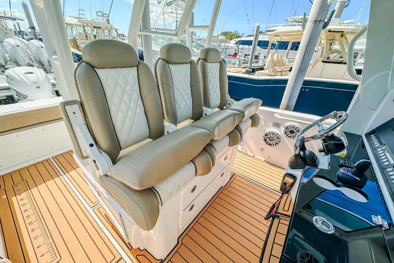Slide: The Image of 2023 Everglades 335 Center Console boat interior with luxurious seating and modern controls. - 24