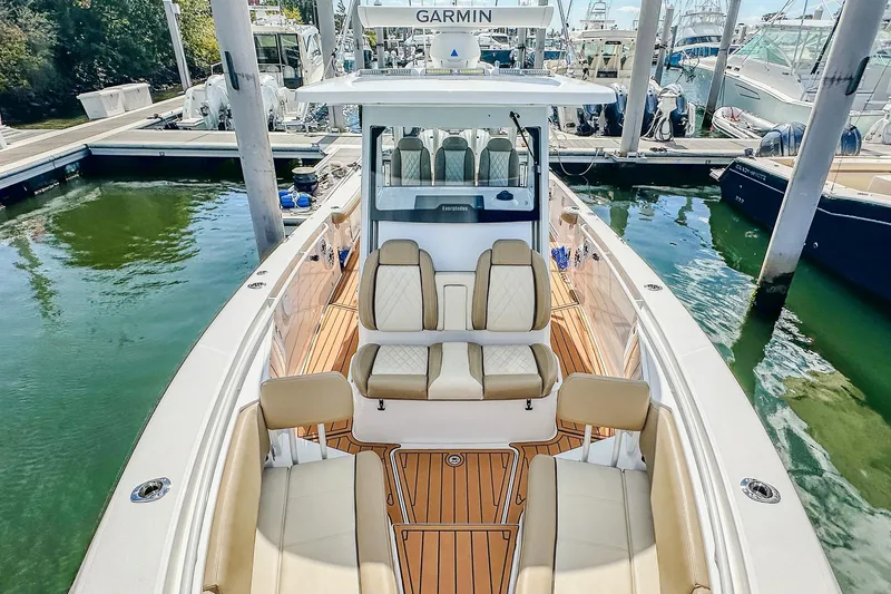 Slide: The Image of 2023 Everglades 335 Center Console boat docked, featuring luxurious seating and advanced navigation. - 27