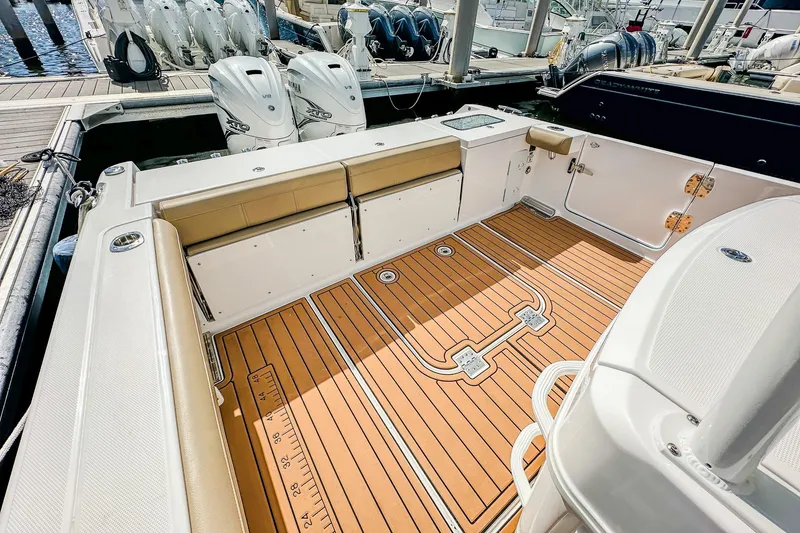 Slide: The Image of 2023 Everglades 335 Center Console boat with teak deck and twin outboard engines. - 30