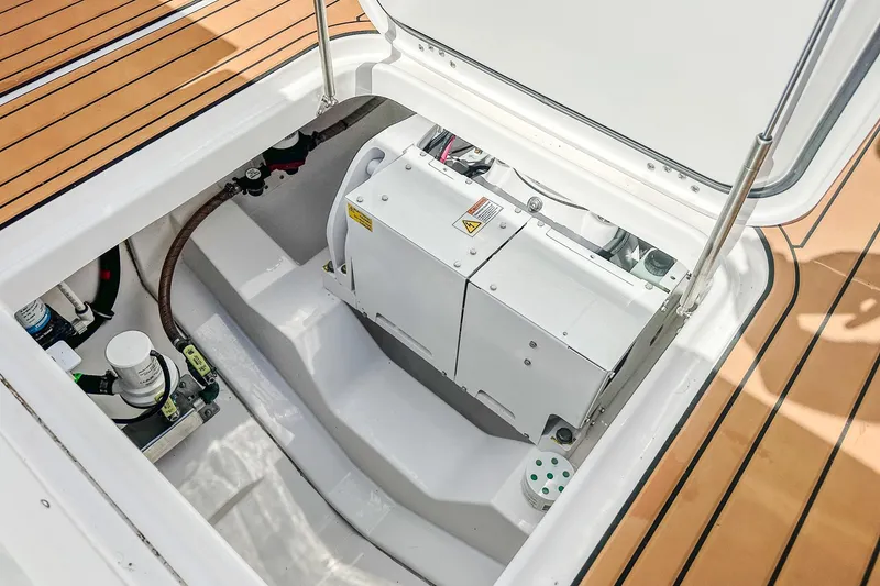 Slide: The Image of 2023 Everglades 335 Center Console engine compartment with open hatch and visible components. - 35