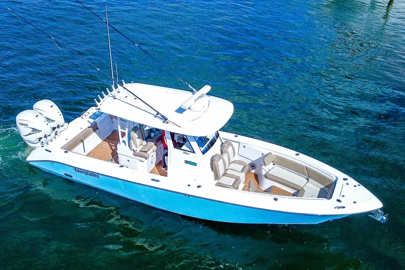 Slide: The Image of 2023 Everglades 335 Center Console boat on clear blue water, showcasing luxury design. - 8